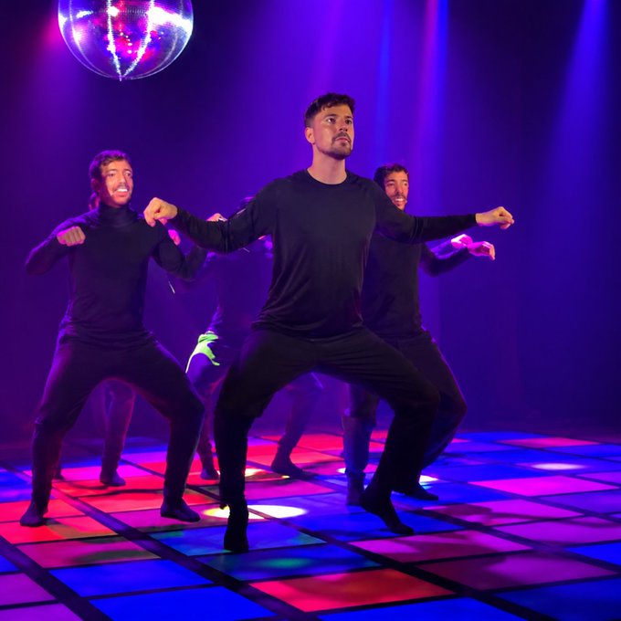 A group of men dressed in black perform energetic dance moves on a colorful, illuminated dance floor with a disco ball overhead and vibrant stage lighting. The dynamic nightclub-style scene evokes a fun, party atmosphere that complements the promotional post about the "MrBeastRizz" token on Pump.fun, which uses this engaging imagery to attract attention to the meme coin.