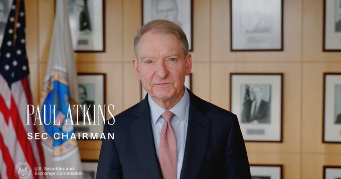 An official portrait of Paul Atkins, identified by on-screen text as 'SEC Chairman', wearing a dark suit and salmon-colored tie, with the U.S. Securities and Exchange Commission seal and flags in the background.