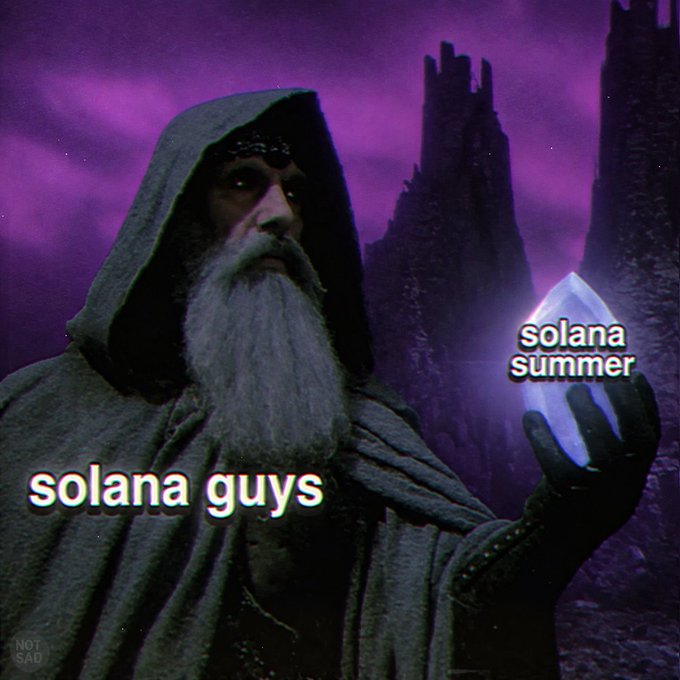 A hooded wizard character holds a glowing blue crystal labeled 'solana summer' while text on his robe reads 'solana guys'.