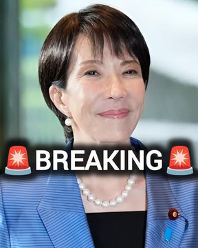 A woman in a blue blazer and pearl necklace smiles in a professional headshot, with a 'BREAKING' news banner and siren emojis overlaid across the image.