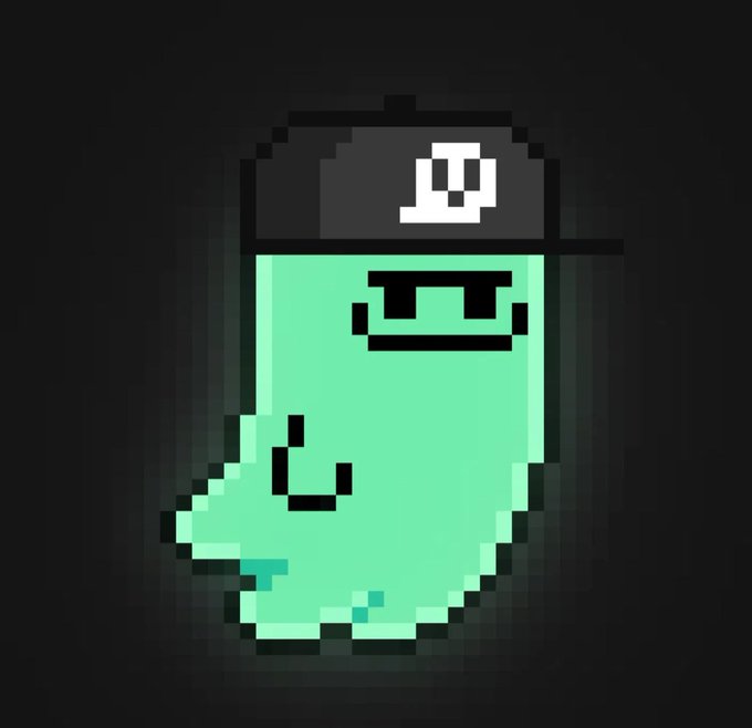 A pixel art illustration of a green, amorphous character wearing a black cap with a white skull emblem, set against a dark background.