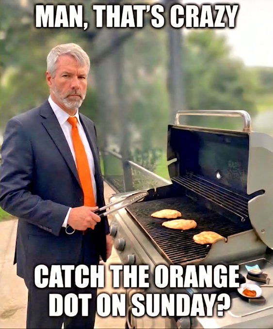 A man in a navy suit with a bright orange tie grills chicken on a barbecue, with text reading "MAN, THAT'S CRAZY" above and "CATCH THE ORANGE DOT ON SUNDAY?" below. The prominent orange tie plays on the meme's reference to "The Orange Dot," likely hinting at Sunday Night Football on NBC (whose peacock logo features an orange dot).