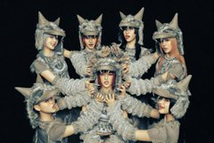 A group of people in grey, textured costumes with horned helmets are posed together, with the text 'comfy in $pack' visible.
