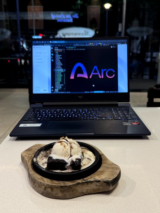 A scoop of ice cream sits on a wooden board in front of an open laptop displaying the Arc browser logo and code, suggesting the developer is enjoying a sweet treat while coding. The scene reflects a relaxed "building" session, aligning with the post about working on the Arc browser.