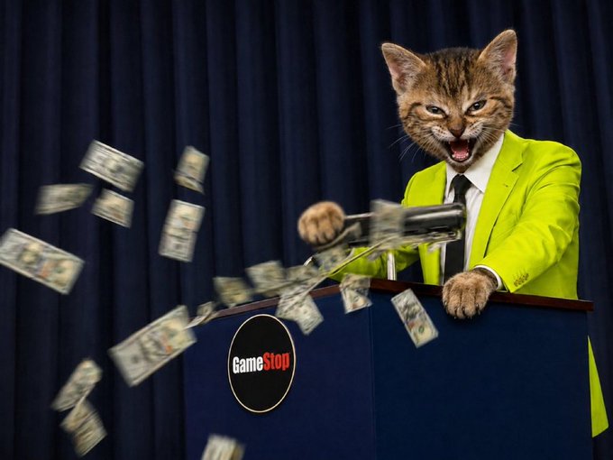 Humor meme featuring a cat's head edited onto a businessman throwing money from a podium labeled 'GameStop' in reference to the GameStop short squeeze.