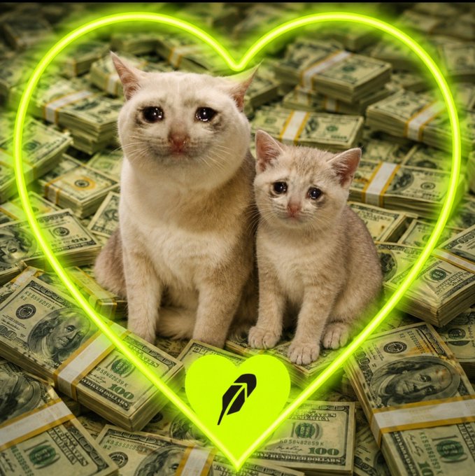 Two cats, one cream-colored and one beige, sit together inside a glowing green heart outline, surrounded by stacks of $100 bills, with a small heart logo at the bottom center.