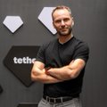 A smiling man, identified by the post as Tether CEO Paolo Ardoino, stands with arms crossed in front of a Tether-branded backdrop featuring the company's diamond logo and "teth" lettering. The juxtaposition of his confident, relaxed pose with the post's caption implies he remains unbothered while crypto holders suffered losses in Q2.