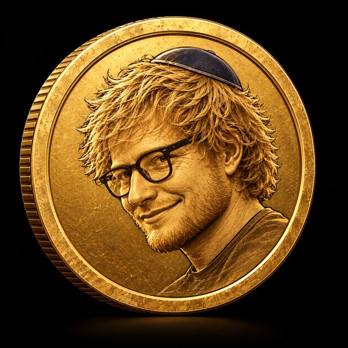 A gold coin featuring a detailed portrait of a smiling man with glasses, blonde hair, and a blue yarmulke.