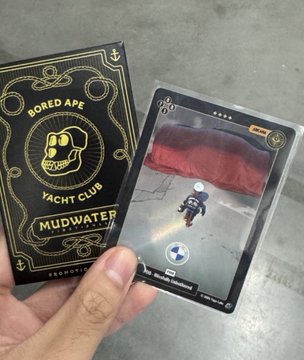 A hand holds two NFT cards side by side: a "Bored Ape Yacht Club Mutant" gold-embossed card on the left, contrasted with an "Ape Yacht Club 91" gorilla image card on the right, visually mocking the gap between Yuga Labs' official releases and lower-effort derivative collections.