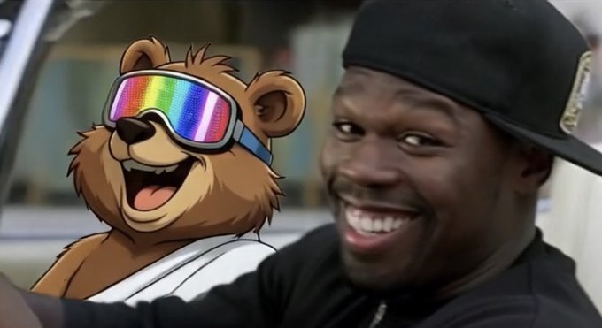 A meme-style image showing a cartoon bear wearing rainbow ski goggles next to a real-life man wearing a black cap and black shirt, who is smiling widely.