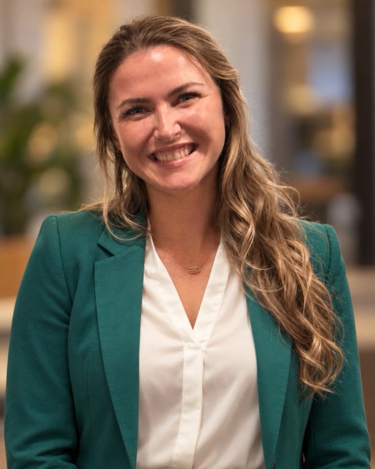 A professional headshot of Elizabeth Thurgaland, a smiling woman with long wavy blonde hair wearing a teal blazer over a white blouse, accompanies her introduction post as co-founder and Head of Talent at BitcoinerTalent, where she helps Bitcoin companies recruit skilled professionals.