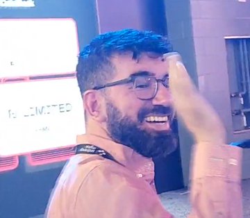 The image shows Coinbase's Chief Policy Officer, Faryar Shirzad, smiling and gesturing with his hand, seemingly in the middle of a discussion. In the background, a screen displays "CLARITY Act," directly tying his appearance to the post's message about over 1 million Americans contacting senators to support the crypto legislation.