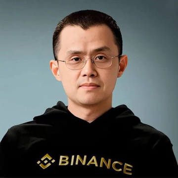 A man with glasses and slicked-back hair wears a black Binance hoodie, shown in a professional headshot. The image relates to the accompanying quote from Binance founder CZ (Changpeng Zhao), who is the subject pictured, expressing his bullish outlook on Bitcoin surpassing gold in importance.