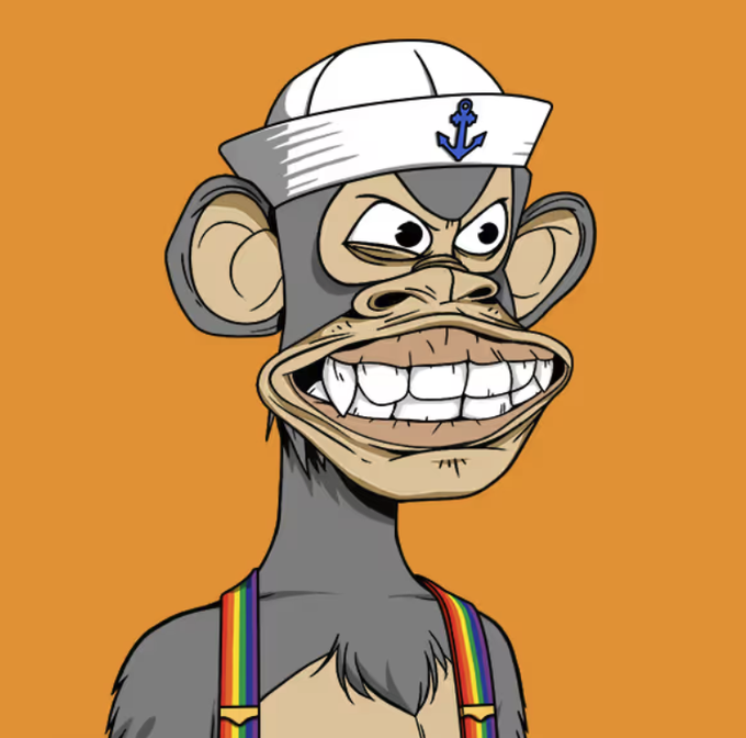 A cartoon illustration of a gray monkey wearing a white sailor hat with a blue anchor symbol and rainbow-colored suspenders, grinning broadly against an orange background.