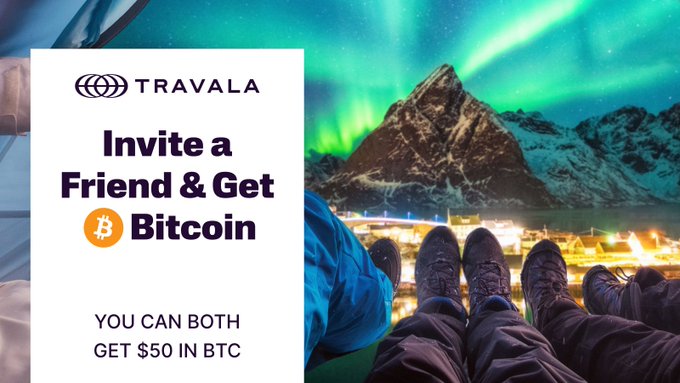 A Travala promotional image featuring the Northern Lights over snow-capped mountains with hikers' boots visible, advertising an "Invite a Friend & Get Bitcoin" referral program offering $50 in BTC to both parties. The visual reinforces the crypto-powered travel booking concept by showcasing an adventurous destination, tying into the post's message about inviting friends for their first trip.