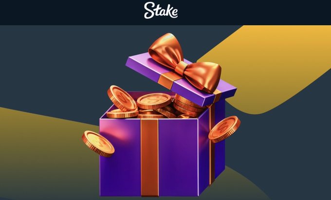 A purple gift box overflowing with gold coins and topped with an orange bow, set against a dark background featuring the "Stake" logo at the top, visually representing a monthly reward or bonus payout on the Stake platform.