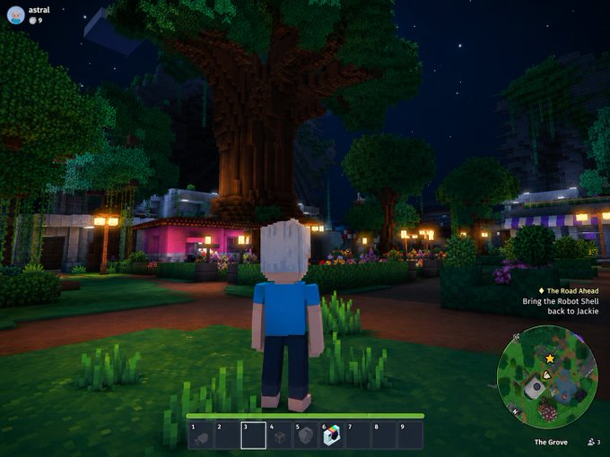 The image shows a man standing in front of a large tree at night within a Minecraft game. The scene appears to be set in a village, with buildings visible in the background. There are also several other people scattered throughout the scene, possibly engaged in various activities or exploring the area. The overall atmosphere seems to be that of an immersive and interactive gaming experience.
