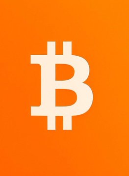The Bitcoin (₿) logo displayed in white on a bright orange background.