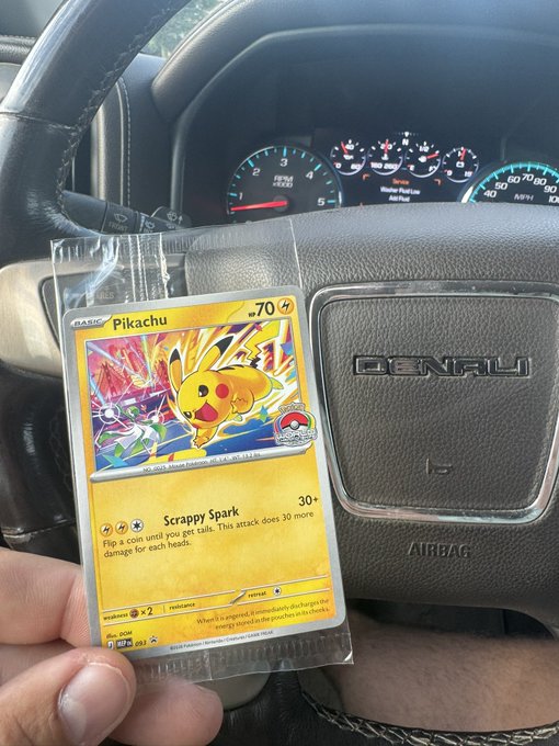 A person holds a holographic Pikachu Pokémon card (70 HP, "Scrappy Spark" attack, 181/203) in a protective sleeve inside a GMC Denali vehicle, having just pulled it as a valuable "bag secured" from a booster pack.