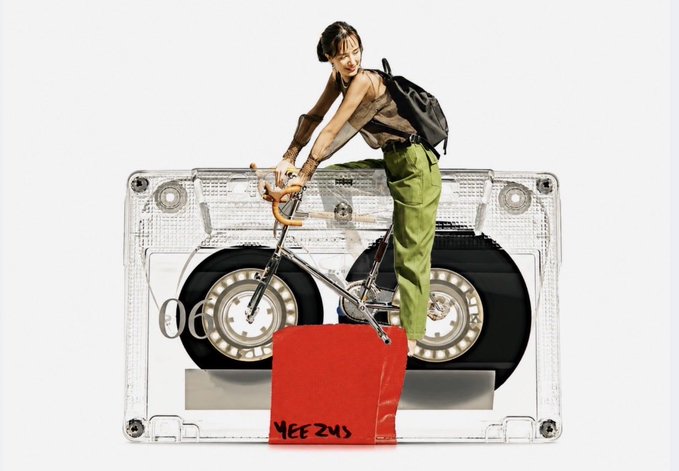 A collage-style digital artwork featuring a shirtless young man with a backpack riding a bicycle in front of a transparent cassette tape revealing two large speakers, with a red tag labeled "YEE ZUS" below. The piece connects to the post title "Riding on Music," merging themes of cycling and music through the surreal juxtaposition of the rider against the boombox cassette backdrop.