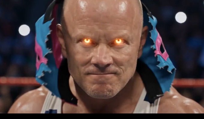 A stylized, edited image of a bald wrestler in a blue and pink mask with glowing orange eyes set in a wrestling ring.