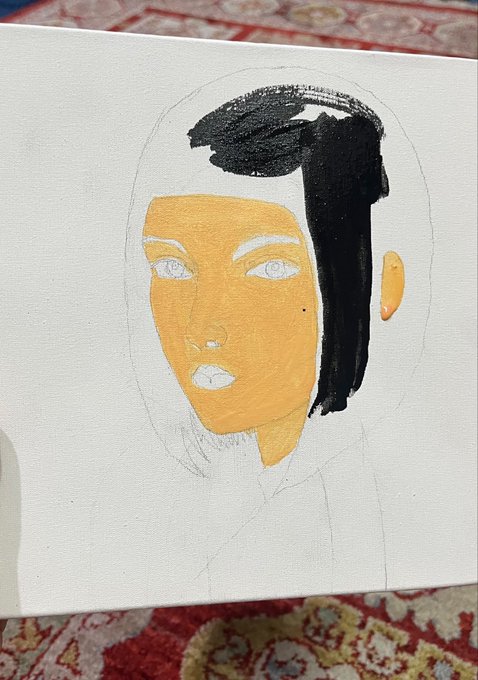 An unfinished acrylic painting on a white canvas showing a portrait with an orange-painted face, black hair, and white pencil sketch lines for the rest of the figure.