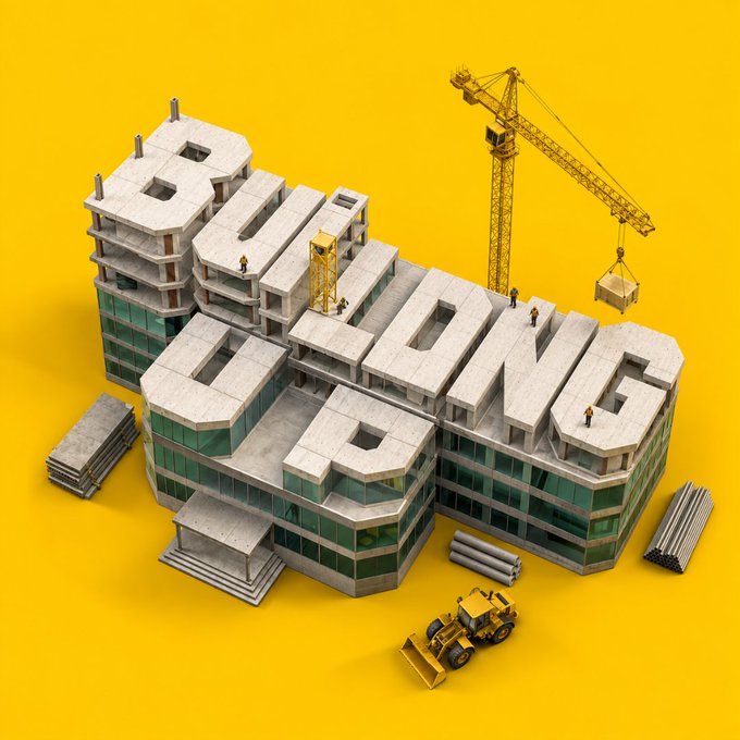 A 3D-rendered construction site scene where the bold text "STILL BUILDING" is spelled out using the rooftops of a multi-story building, surrounded by a crane, bulldozer, and tiny construction workers, set against a vibrant yellow background—visually reinforcing the message that progress and growth are ongoing.
