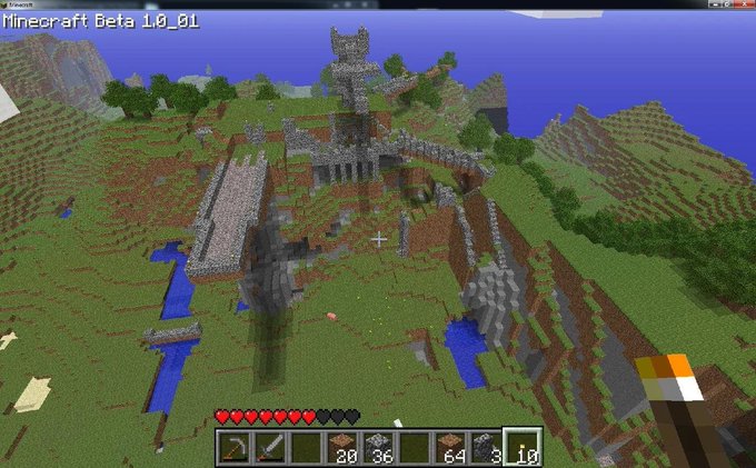 A Minecraft Beta 1.0_01 screenshot showing a grassy landscape with a stone castle structure and a river.