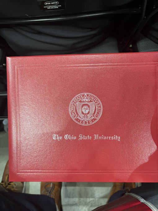 A proud graduate displays their red leather-bound diploma cover from "The Ohio State University," featuring the university's official seal and "1870" founding date, celebrating their achievement. The "Made it" caption reflects the accomplishment of earning their degree.