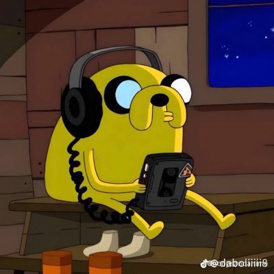 Jake the Dog from Adventure Time wearing headphones and holding a portable cassette player/device while sitting on a bench.