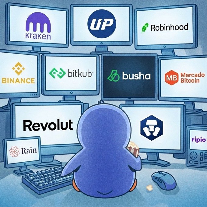 urn of gold coins, a blue penguin, and a computer monitor with Bitcoin logos are arranged on a table.