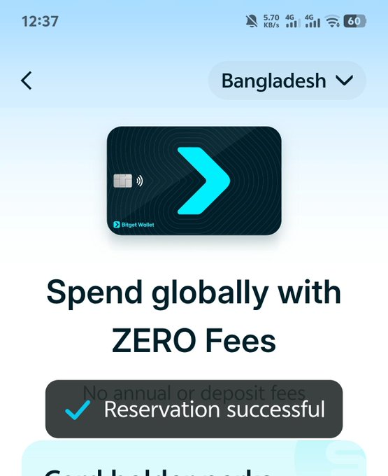 The image shows a mobile phone screen displaying information about a Bitget Wallet Visa Card from Bangladesh. The card has been approved, and the user can now spend globally with zero fees. The text on the screen reads " Spend Globally with Zero fees", indicating that the card is accepted for international transactions without any annual or immediate deposit fees. The user should wait for the next update before applying for the card to ensure they receive the benefits of this new Visa card.