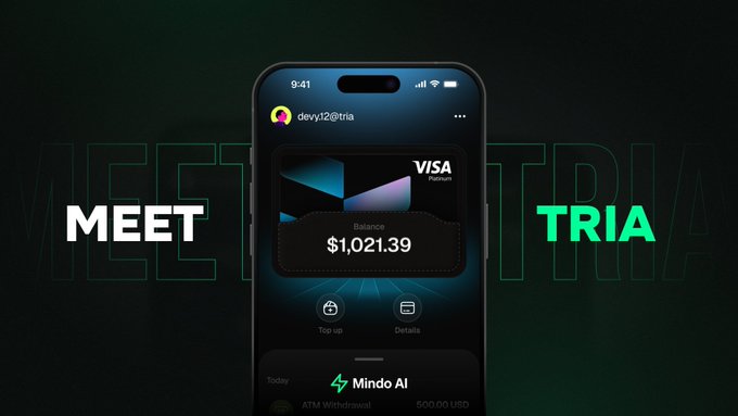 A promotional graphic with the words 'MEET' on the left and 'TRIA' in green on the right, featuring a smartphone displaying a Visa Platinum card with a $1,021.39 balance under the username 'devy12@tria'.