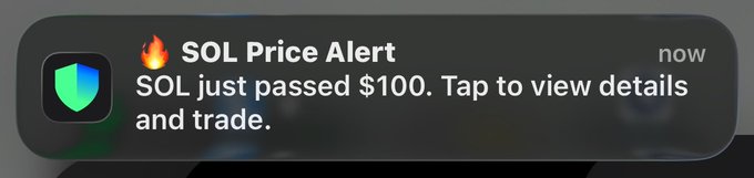 A mobile notification reading "🔥 SOL Price Alert — SOL just passed $100. Tap to view details and trade." This alert aligns with the post celebrating $SOL's upward momentum, serving as a visual confirmation of the price milestone that prompted the giveaway offer.