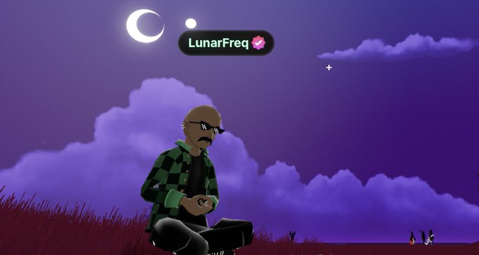 The image features a man sitting cross-legged with his legs crossed, holding a laptop computer. The background of the image shows a purple sky filled with clouds, giving off a dreamy atmosphere. There are also two small white crescents in the top left corner and a large white moon in the top right corner. The post mentions that the man was meditating on @decentraland at the Community Building Decentraland's 4 year anniversary party.
