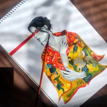 A sketchbook page featuring a detailed colored illustration of a woman in a vibrant, patterned red and yellow traditional-style garment, with a red ribbon bookmark and soft shadows across the page.