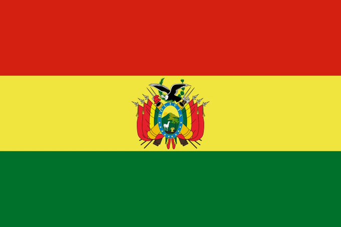 The flag of Bolivia, featuring horizontal red, yellow, and green stripes with the national coat of arms in the center, is displayed as Bolivia considers adding USDT to its national payment system amid dollar shortages.
