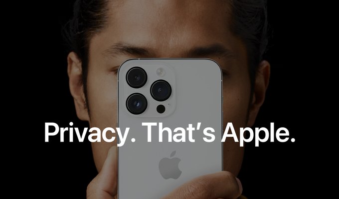 An Apple advertisement featuring a person holding an iPhone that obscures their face, with the tagline "Privacy. That's Apple."