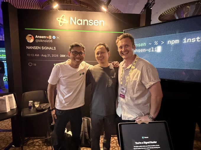 Three men pose together at a Nansen booth during the Solana Summit, with visible on-screen text showing "Nansen," "Nansen Signals," a timestamp of "10:13 AM - Aug 21, 2026," and the handle "@blknol206," alongside a terminal display referencing "nansen-cli." The image visually aligns with the post's caption celebrating three industry figures—Bobby Ong, @mtbitcoin, and Alex Svanevik—gathering at the event, with Svanevik (Nansen's CEO) hosting the booth.