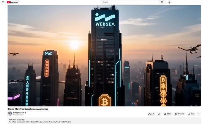 A YouTube music video titled "Bitcoin Man: The Superhuman Awakening" by Herbert R. Sim shows a futuristic cyberpunk cityscape featuring a prominent skyscraper labeled "WEBSEA," with a Bitcoin logo glowing in neon. The video, which celebrates cryptocurrency themes, aligns with the post celebrating its approaching 1 million views, and was posted 2 days ago with 2.9K likes.