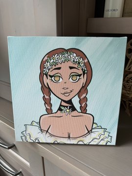 A wooden painting on a shelf depicts a girl with braided hair, a floral crown, and yellow eyes against a light blue background.