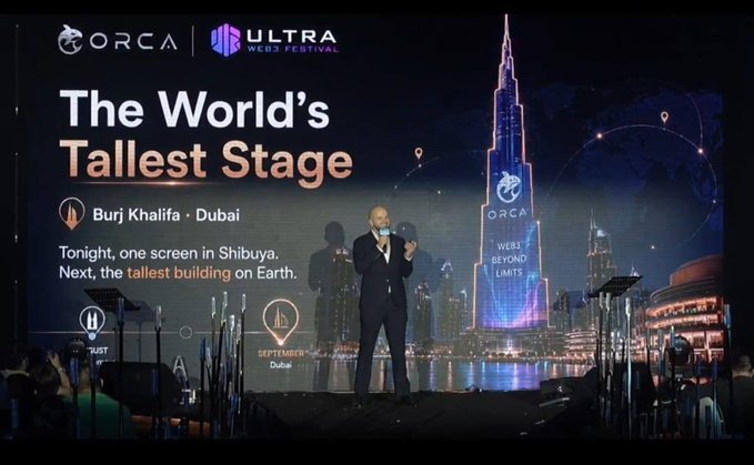 A presentation at the ORCA Ultra Web3 Festival titled 'The World's Tallest Stage' featuring 'Burj Khalifa · Dubai' with the tagline 'Tonight, one screen in Shibuya. Next, the tallest building on Earth.'