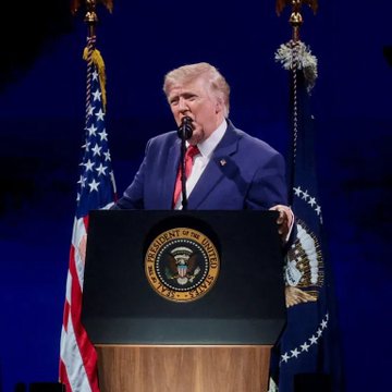 Donald Trump speaks at a podium bearing the Seal of the President of the United States, flanked by U.S. flags.