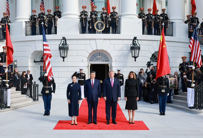President Donald Trump and First Lady Melania Trump welcome Chinese President Xi Jinping and Peng Liyuan to the White House, posing together on a red carpet with American and Chinese flags. This image visually represents the partnership between the US and China mentioned in the post, suggesting a significant shift in global relations.