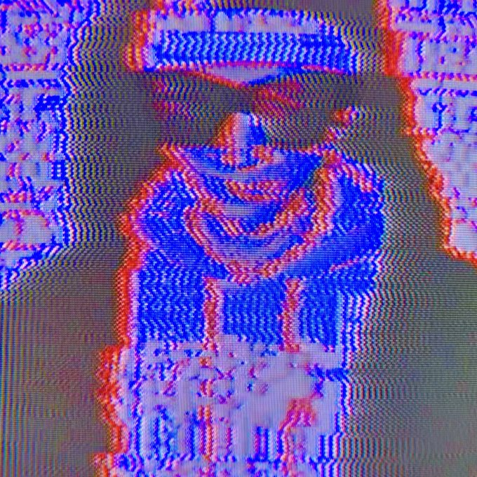An abstract digital image with pixelated blue and red patterns resembling a CRT screen or glitch art.