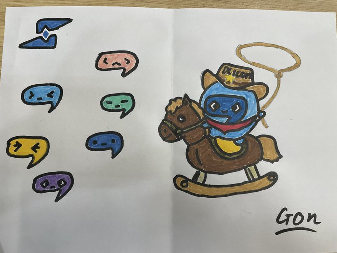 A child's hand-drawn artwork showing a blue character on a rocking horse with a lasso, wearing a hat labeled 'DRICOT', surrounded by colorful face mask stickers, signed 'GON' in the bottom right.
