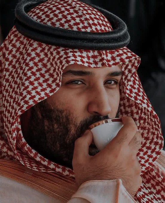 A close-up portrait shows a man wearing a traditional red and white keffiyeh and black agal, drinking from a small white cup.
