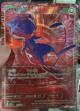 The image shows a Pokémon trading card featuring Mew, with its "Psychic" attack dealing 10 damage and text reading "The next Mew card you play this turn does its attacks on your opponent's Pokémon VSTAR that are already in play." The card displays "60" HP, "BASIC," and the 156/165 set number, shown with a vibrant rainbow holographic foil effect that the post excitedly confirms as a real RGB (Rainbow/Gold) variant despite its unusual appearance.