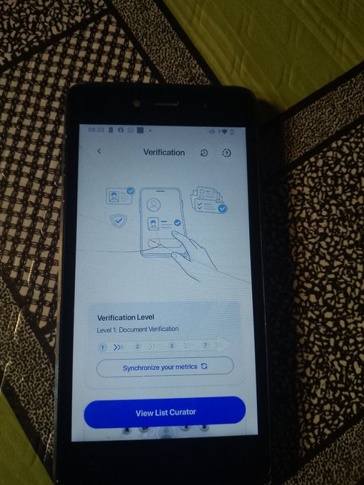 A smartphone displays a 'Verification' screen showing 'Verification Level: Level 1: Document Verification' with a 'Synchronize your metrics' button and a blue 'View List Curator' button.