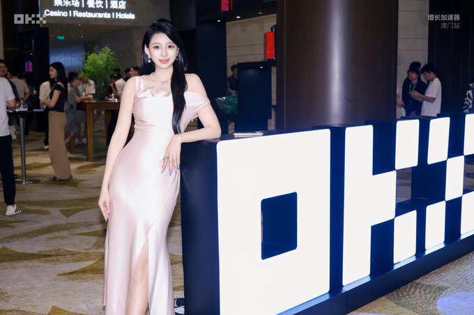 A woman in an elegant off-the-shoulder pink satin gown poses beside large "OP.GG" signage at what appears to be a gaming or esports event, with background banners reading "Casino | Restaurants | Hotels" and Chinese characters indicating a Macau location. The post celebrates her as "Misa," suggesting she is a beloved public figure or content creator, with the caption admiringly declaring that the world belongs to the younger generation.